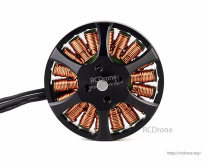 Top view of a T-Motor brushless outrunner motor with exposed copper windings and three-phase leads