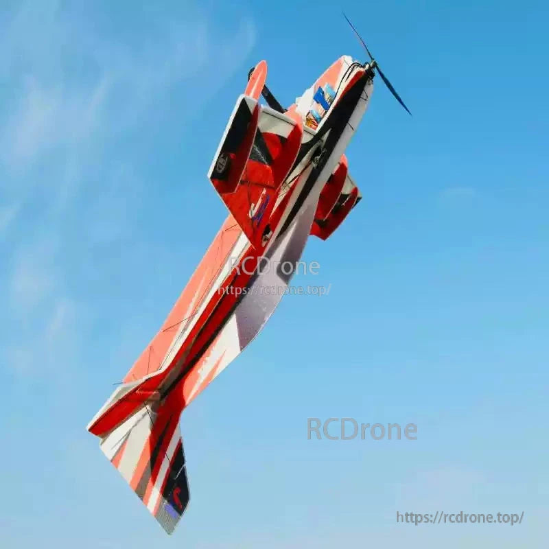 T-Motor, Red and white RC aerobatic airplane flying vertically against a clear blue sky with front propeller