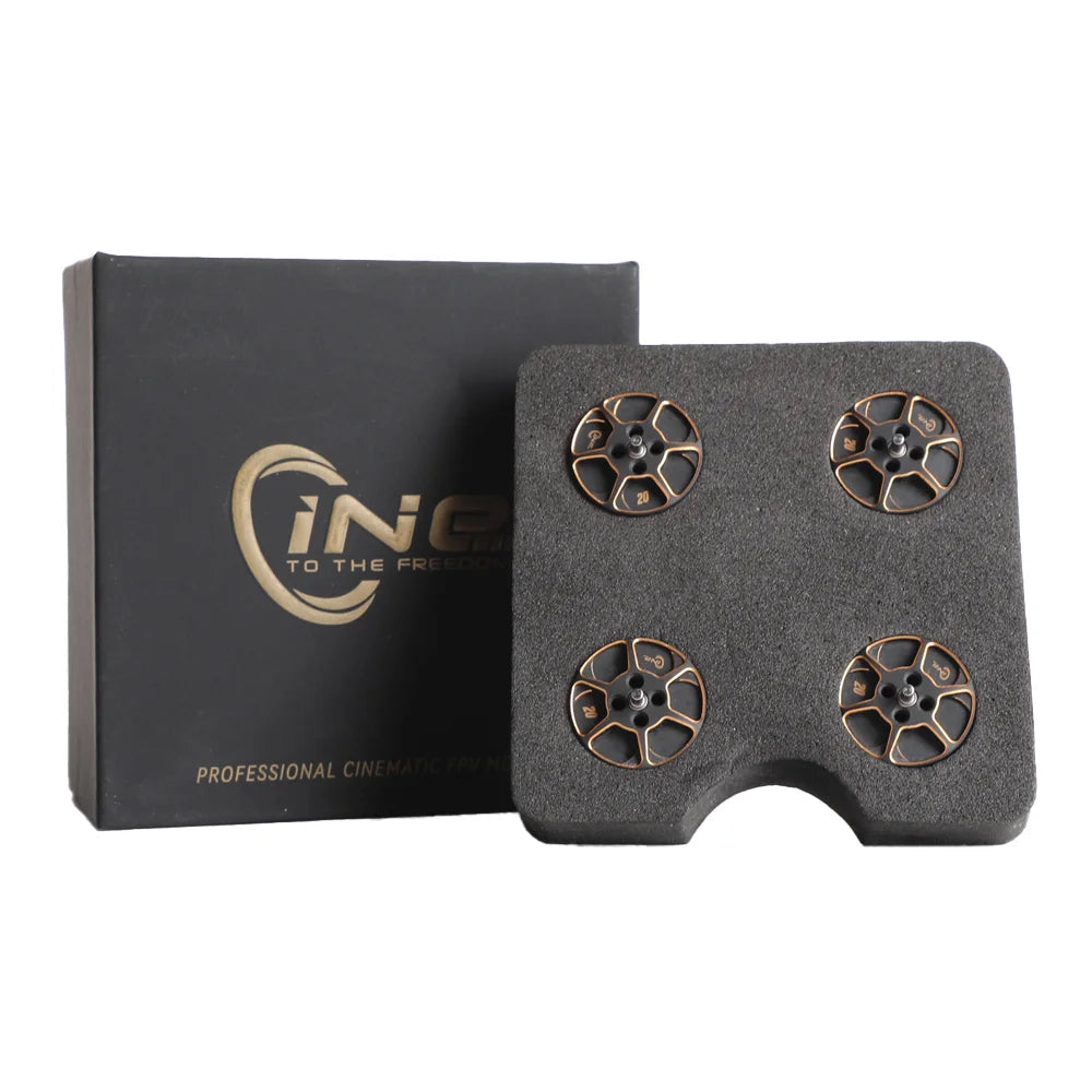 Four black and gold T-Motor components in a foam tray next to a branded box