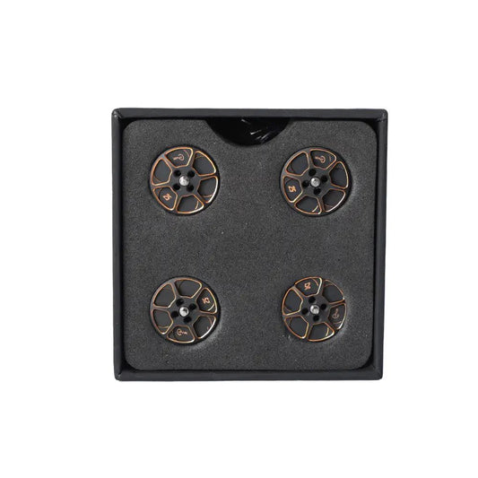 Set of four black and gold anodized T-Motor drone motor parts arranged in a foam-lined box
