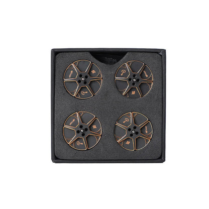 Set of four black and gold T-Motor round metal components with center mounting holes in foam packaging