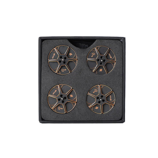 Set of four black and gold T-Motor round metal components with center mounting holes in foam packaging