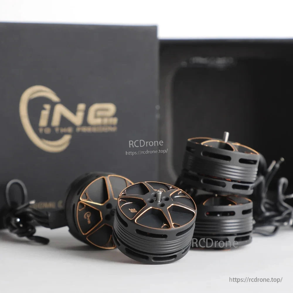 T-Motor, Set of four black and gold brushless drone motors with mounting screws and packaging in the background