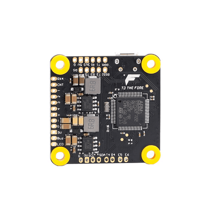 T-Motor F7 HD flight controller board with STM32F722 chip, labeled solder pads, and four yellow mounting grommets