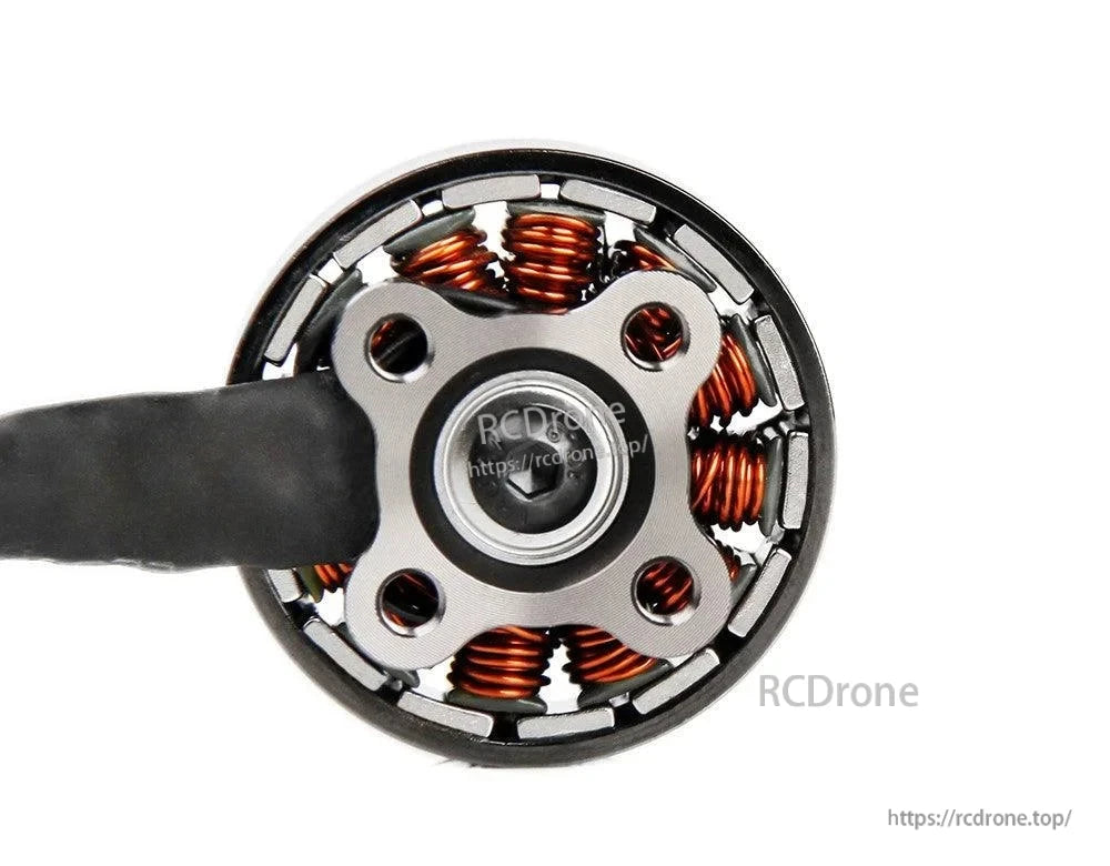 Bottom view of a T-Motor brushless drone motor showing copper windings, central shaft screw, and 4-hole mount