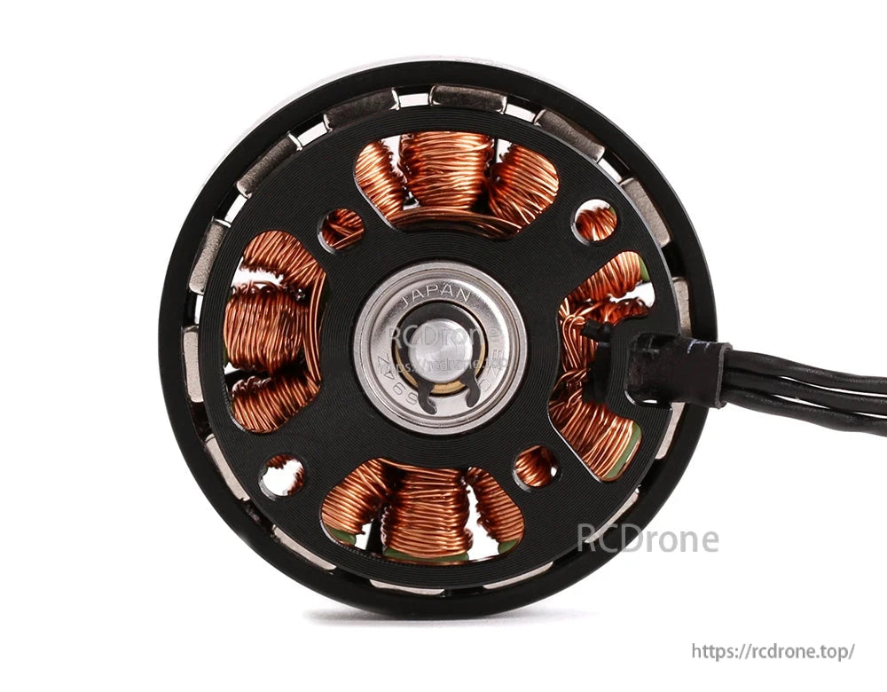 Close-up of T-Motor brushless drone motor base with exposed copper windings, bearing center, and lead wires