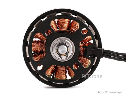 Close-up of T-Motor brushless drone motor base with exposed copper windings, bearing center, and lead wires
