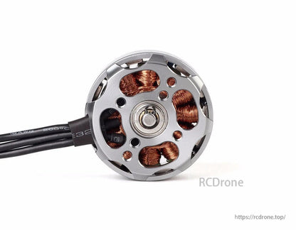 T-Motor brushless drone motor close-up with silver outrunner housing, visible copper windings, and attached wires