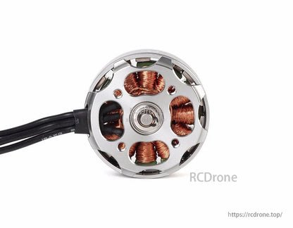 Close-up of a T-Motor brushless outrunner drone motor with silver housing, exposed copper windings and lead wires