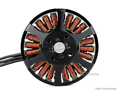 Bottom view of a T-Motor brushless drone motor showing copper windings, central mounting hub, and power wires