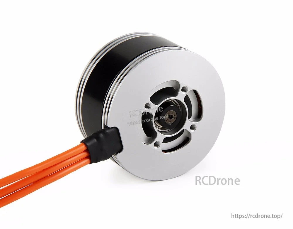 Close-up of a T-Motor brushless drone motor with silver vented end cap, black housing, and orange power wires