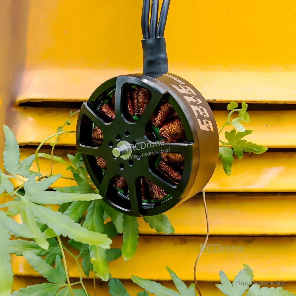 T-Motor brushless drone motor with open-frame black housing, exposed copper windings, shaft and three-wire lead