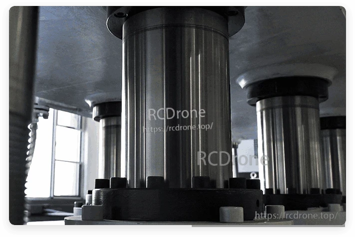 Close-up of industrial machine columns with bolted base plates inside a workshop setting