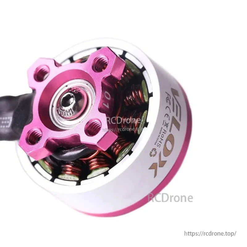 Close-up of T-Motor LETOX brushless drone motor with pink aluminum top mount and exposed copper windings