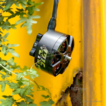 Close-up of a T-Motor brushless outrunner drone motor with silver housing, exposed windings, and cable lead