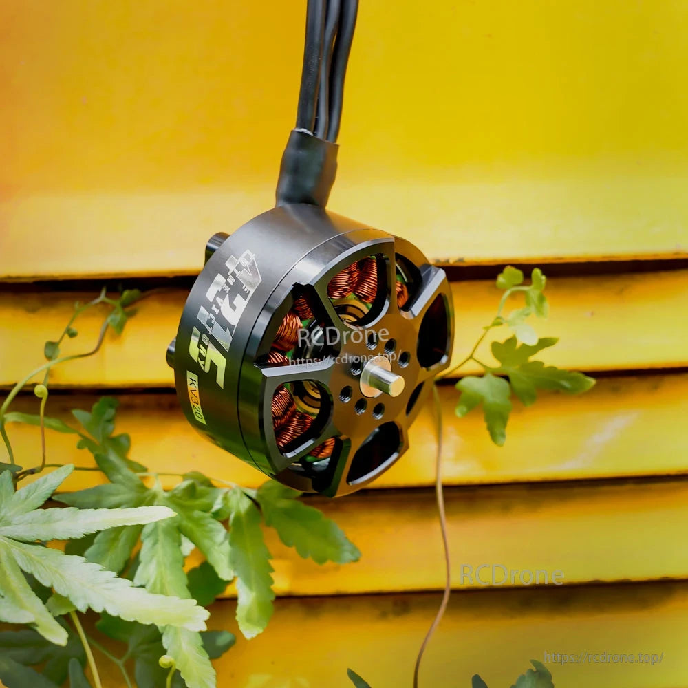 T-Motor brushless drone motor close-up with exposed copper windings, front mounting face, and three power leads