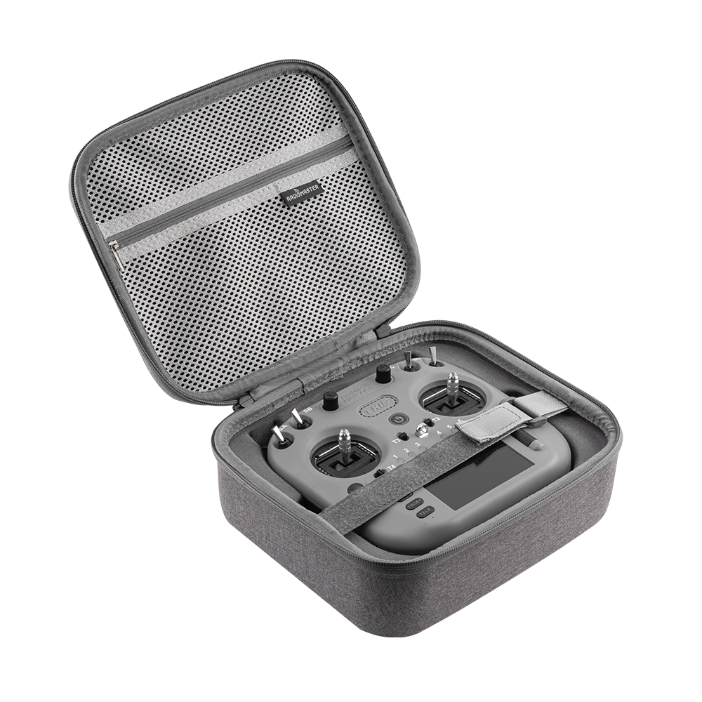Open TX15 radio case showing molded interior, mesh pocket and securing strap holding transmitter