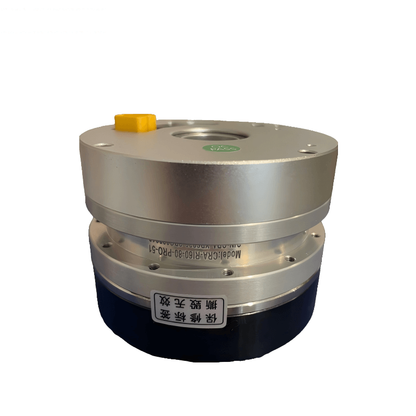 Side view of robot motor joint module with metal housing, yellow capped connector, and safety label