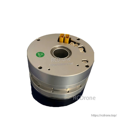 Angled view of joint actuator showing faceplate cutouts, yellow power terminals, and center bore