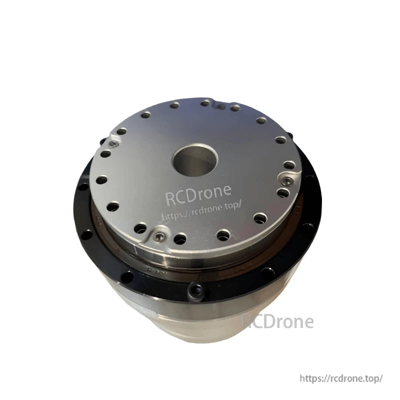 Angled top view of motor joint module showing circular mounting plate, center bore, and fastener holes