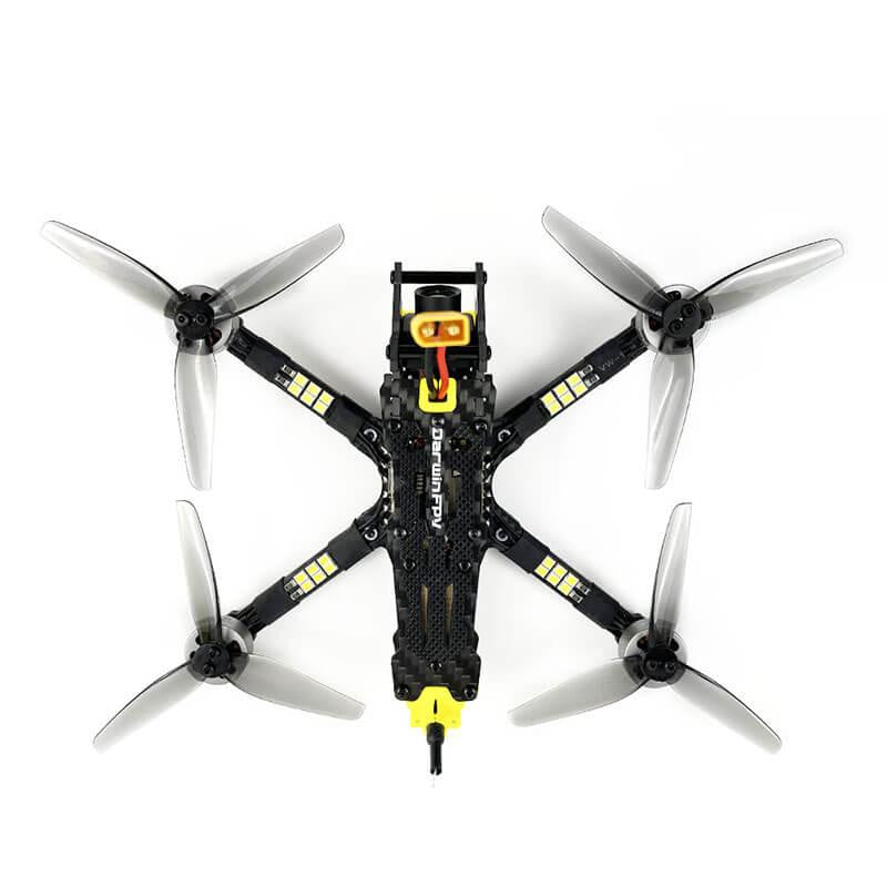 Overhead view of DarwinFPV racing drone showing four propellers, carbon fiber frame, and LED strips on arms