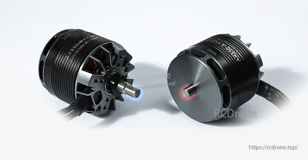 Two black T-Motor brushless drone motors with exposed shafts and attached power leads on a white background