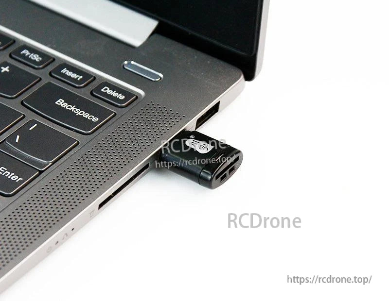 Micro SD/TF USB card reader plugged into a laptop USB port for data transfer