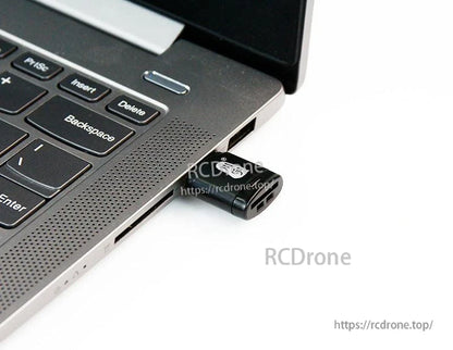 Micro SD/TF USB card reader plugged into a laptop USB port for data transfer