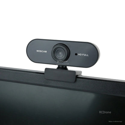 Webcam clipped to top of a monitor, front view showing WEB CAM label and HD FULL light