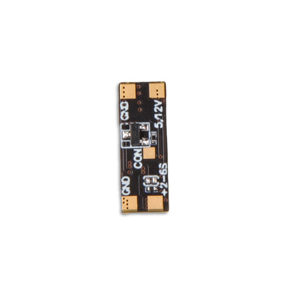 Flywoo 5V/12V 2A BEC regulator board with solder pads labeled GND, COM, 12V, and +2–6S input