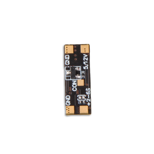 Flywoo 5V/12V 2A BEC regulator board with solder pads labeled GND, COM, 12V, and +2–6S input