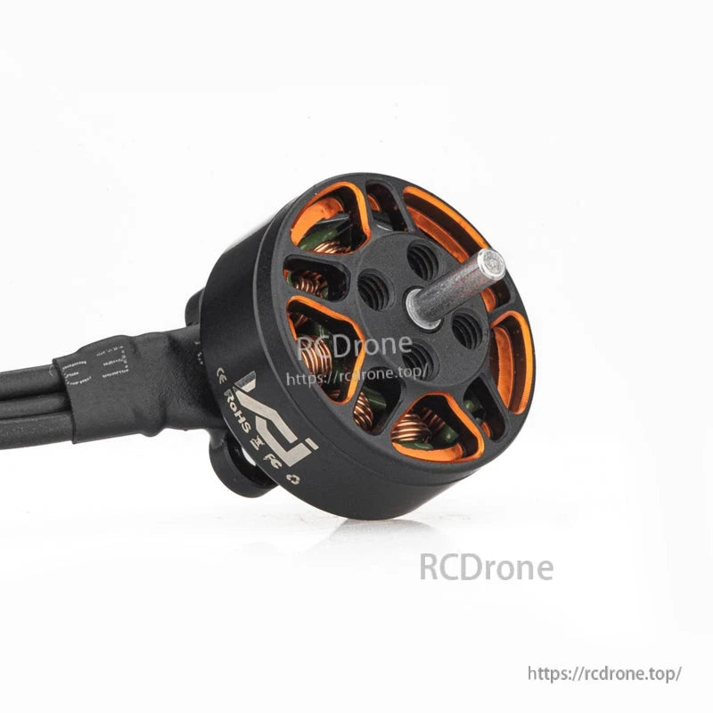 Angled view of brushless motor with output shaft and open bell revealing copper windings