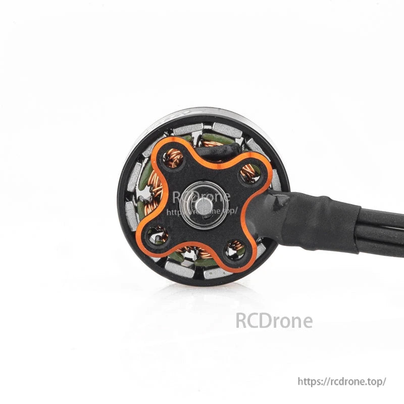 Bottom view of 1104 brushless motor base with four mounting holes, copper windings, and wire bundle