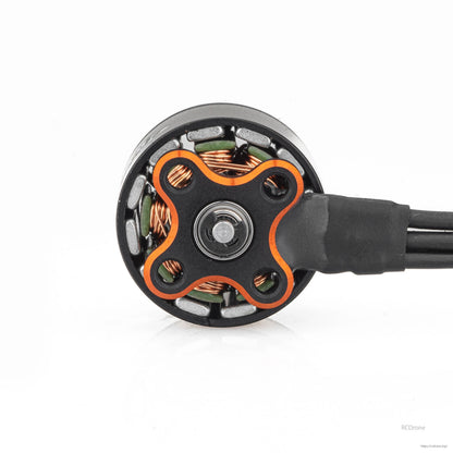 Bottom view of motor base showing four-lobe mounting plate, bearing center, and wire lead