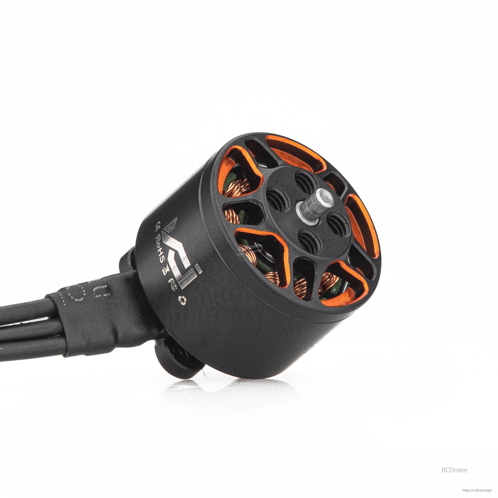 Angled close-up of motor bell and shaft, showing orange accents and wire lead exit
