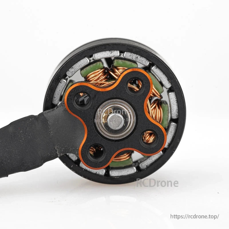 Bottom view of motor showing bearing hub, base plate, and internal magnets and windings