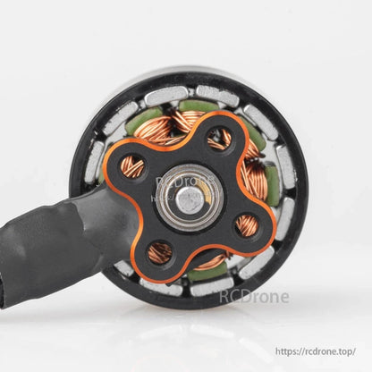 Bottom view showing motor base with four mounting holes, bearing, and visible copper windings