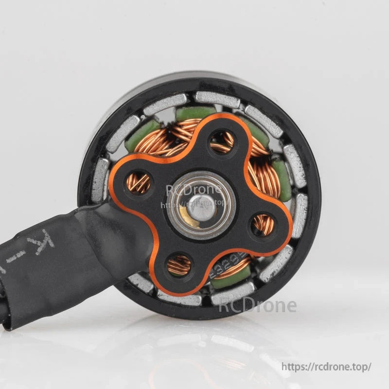 Bottom view showing mounting base, central bearing, and internal windings around the stator
