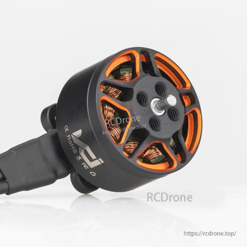 Angled top view of SPARK 1306 motor showing threaded prop mount holes and orange bell cutouts