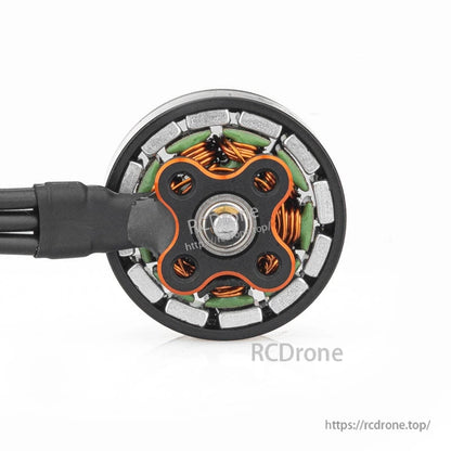 Bottom view of motor showing base plate, copper windings, and magnet ring inside the stator