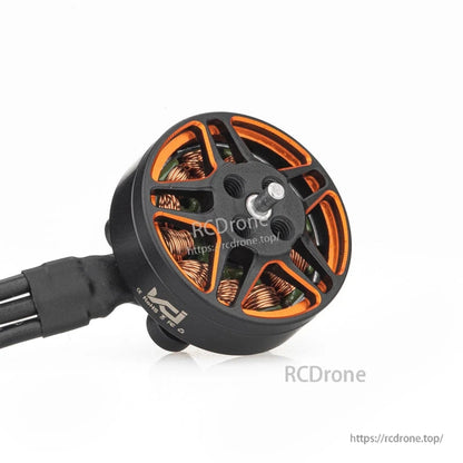 Angled close-up of motor bell with orange accents, center shaft, and winding details