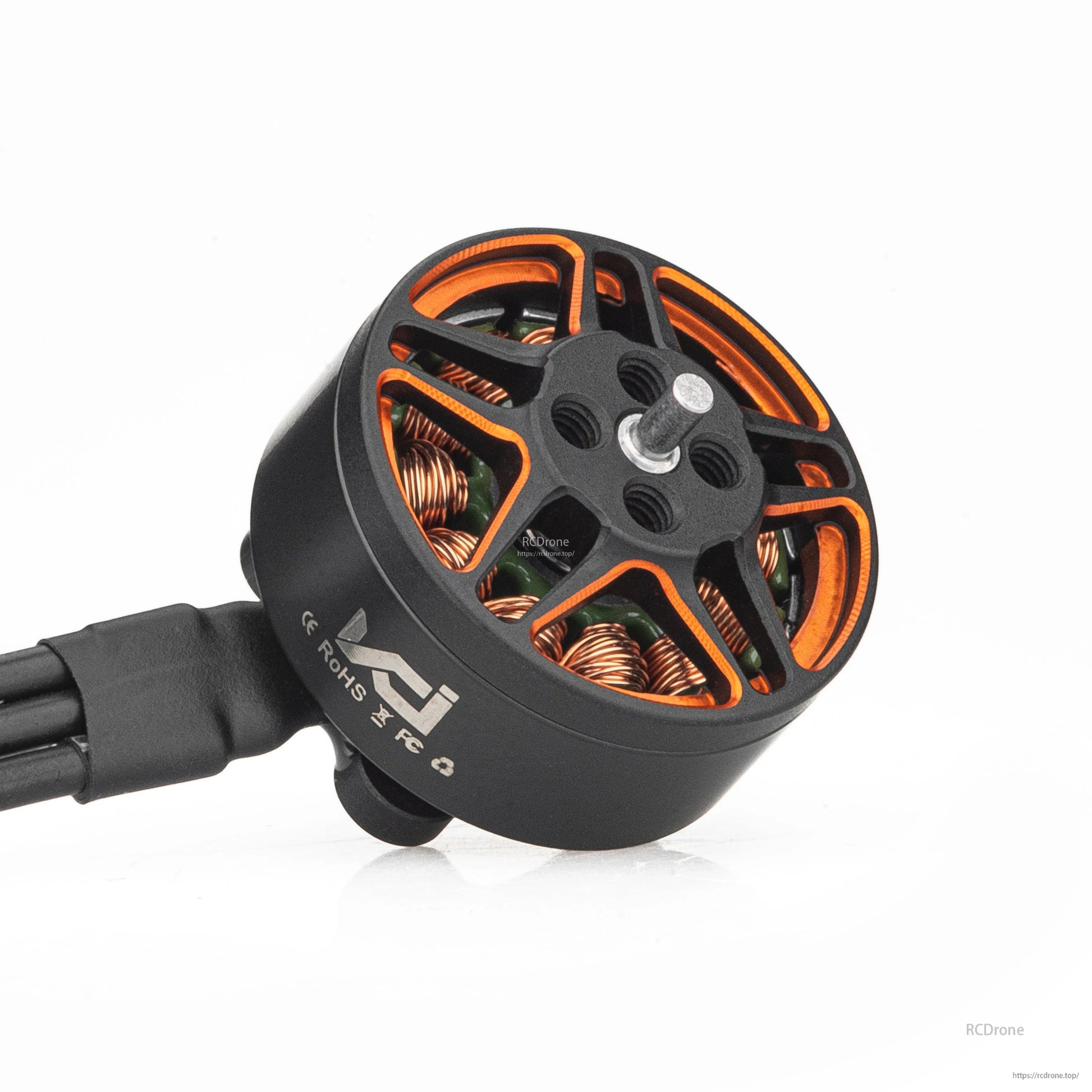 Angled view of brushless motor with orange-accent rotor, center shaft, and side marking on the can