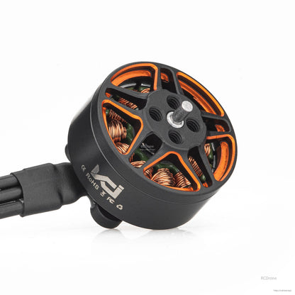 Angled view of brushless motor with orange-accent rotor, center shaft, and side marking on the can