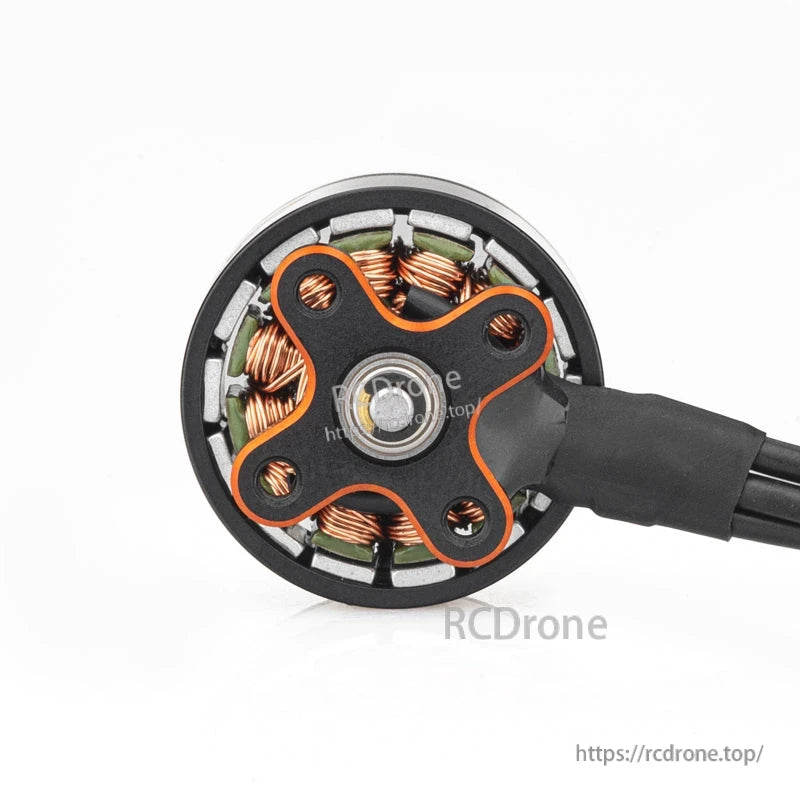 Bottom view of motor showing base plate, bearing center, and copper windings around the stator