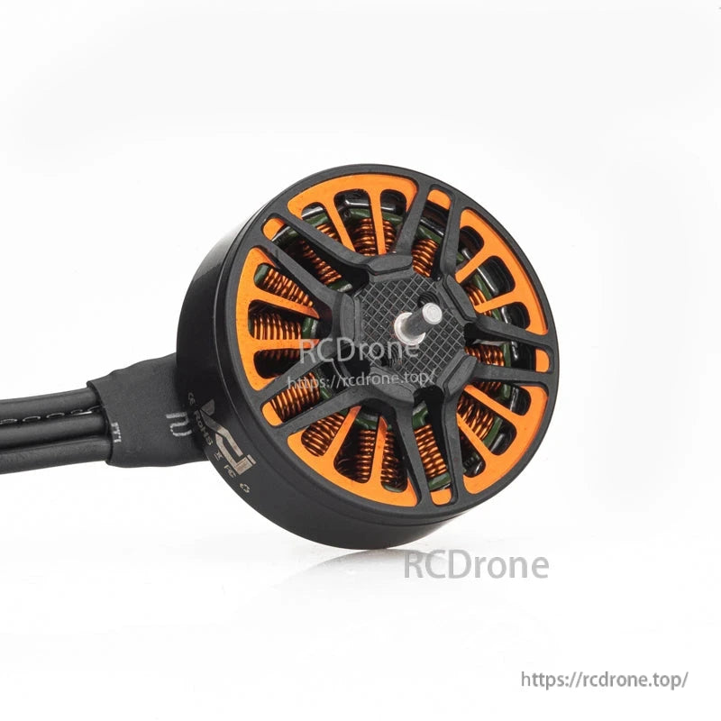 Angled view of VCI SPARK 2005 brushless motor bell with vented orange stator and wire lead