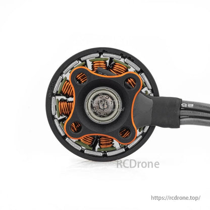 Bottom view of motor base showing mounting pattern, bearing hub, and copper windings around the stator