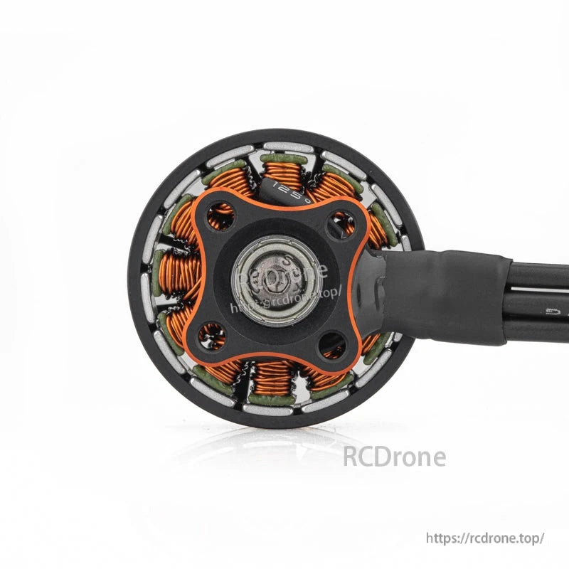 Bottom view showing mounting base, screw holes, and exposed copper windings around the stator