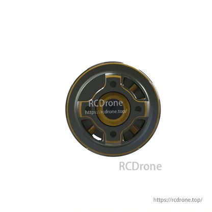 Bottom view of FPV drone motor base showing mounting holes and visible copper windings