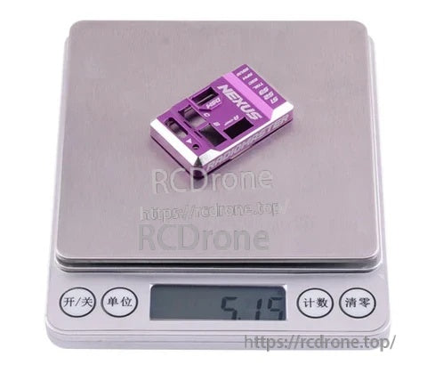 Purple Nexus aluminum flight controller case on scale showing approximately 5.15 g weight