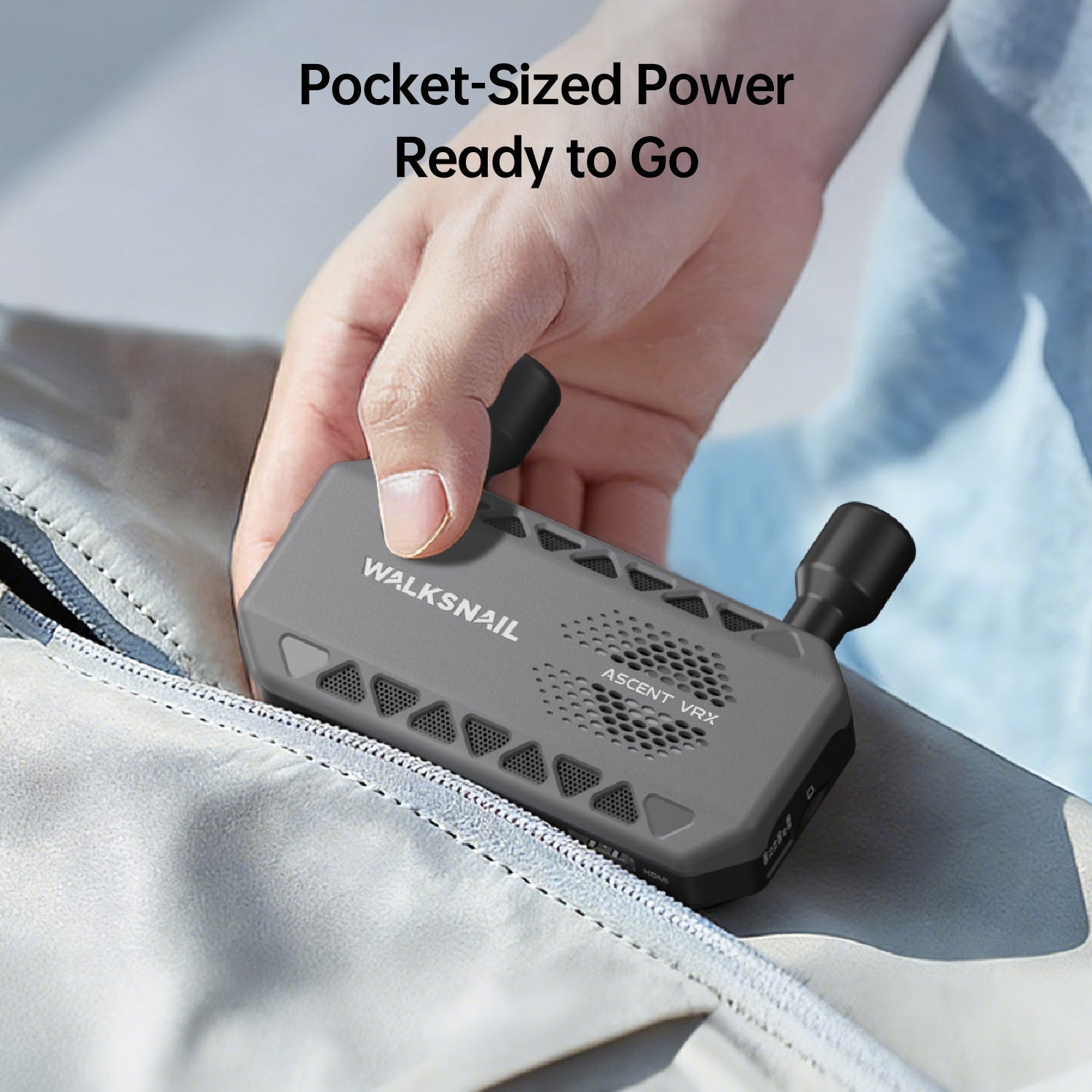 Hand holding the compact receiver, emphasizing pocket-sized design for travel and field use